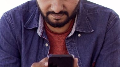 People using smartphones on a busy street in India