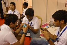 A student learning with a smartphone and headphones
