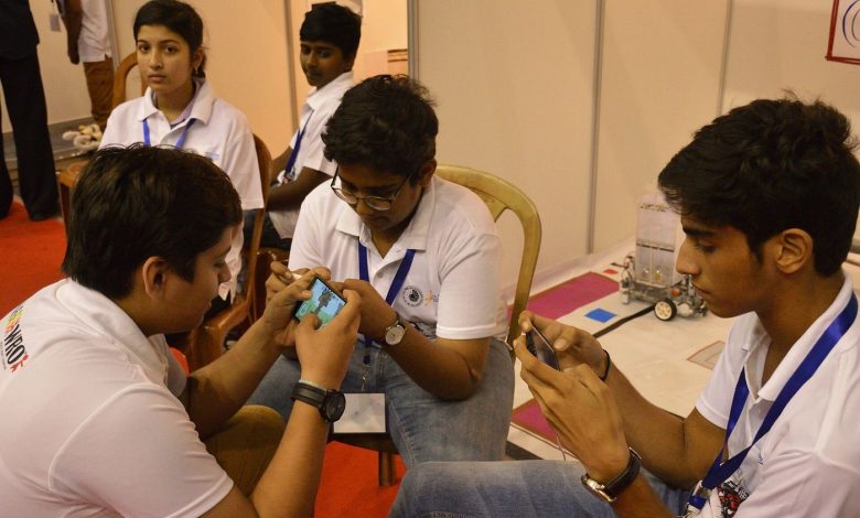 A student learning with a smartphone and headphones